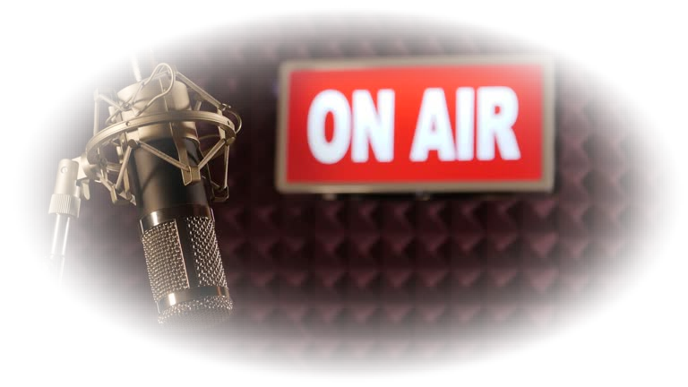 Stock 4K Video clip footage of an On Air Sign being switched on and Illuminated. It's filmed with a microphone in the foreground. Perfect for a Recording or TV Studio or Radio Station. Camera Dolly